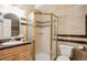 Updated bathroom featuring a glass shower stall, single sink, and ceramic tile walls at 18027 E Ida Dr, Centennial, CO 80015