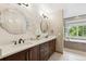 Bright bathroom features a double vanity with granite counters, and textured accent wall at 18027 E Ida Dr, Centennial, CO 80015