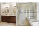 This bathroom features tiled floors, double vanity, granite countertops, and a glass enclosed shower at 18027 E Ida Dr, Centennial, CO 80015