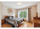 Bedroom with hardwood floors, neutral walls, area rug and large window, with plenty of natural light at 18027 E Ida Dr, Centennial, CO 80015