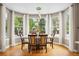 Bright dining room with large windows, hardwood floors, and modern lighting fixture at 18027 E Ida Dr, Centennial, CO 80015