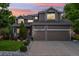 Charming two-story home featuring a covered porch, landscaped front yard, and attached two-car garage at 18027 E Ida Dr, Centennial, CO 80015