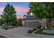 Beautiful two-story home with a two-car garage, well-manicured lawn, and lush landscaping at 18027 E Ida Dr, Centennial, CO 80015