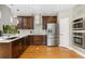 Modern kitchen with stainless steel appliances, dark wood cabinets, and hardwood flooring at 18027 E Ida Dr, Centennial, CO 80015