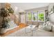 Inviting living room with hardwood floors, staircase, large windows, and a neutral color palette at 18027 E Ida Dr, Centennial, CO 80015