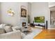 Bright living room features a cozy fireplace, modern decor, and a large entertainment center at 18027 E Ida Dr, Centennial, CO 80015