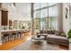 Open-concept living room with high ceilings, large windows, and modern furnishings at 18027 E Ida Dr, Centennial, CO 80015