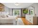 Serene main bedroom features a large window, plush bedding, and a decorative dresser at 18027 E Ida Dr, Centennial, CO 80015
