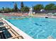 Community pool with lap lanes, lounge chairs, and lifeguard stand at 18027 E Ida Dr, Centennial, CO 80015