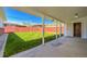 Covered patio overlooks the spacious backyard with a well-maintained lawn and a tall privacy fence at 7651 Shoshone St, Denver, CO 80221