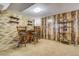 Finished basement bar area with wooden paneling and room for seating creating a cozy space at 7651 Shoshone St, Denver, CO 80221
