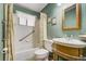Bathroom with vintage wooden vanity and mirror offering functionality and unique design at 7651 Shoshone St, Denver, CO 80221