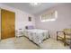 Bedroom with floral bedding, window with blind, and side table offers a serene retreat at 7651 Shoshone St, Denver, CO 80221