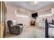 Relaxing bedroom with soft pink walls, a comfortable chair, and ample natural light at 7651 Shoshone St, Denver, CO 80221
