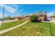 Beautifully landscaped front yard of a brick home with green lawn and clear walkway at 7651 Shoshone St, Denver, CO 80221