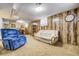 Finished basement living room with wood paneling and room for seating creating a cozy space at 7651 Shoshone St, Denver, CO 80221