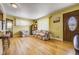Cozy living room with hardwood floors, natural light, and a classic wood door at 7651 Shoshone St, Denver, CO 80221