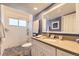 Modern bathroom with a glass-enclosed shower, stylish tile, and a large vanity mirror at 2117 S Troy Way, Aurora, CO 80014