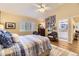 Inviting bedroom with shuttered windows, a ceiling fan, wood-look floors, and charming decor at 2117 S Troy Way, Aurora, CO 80014