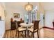 Bright dining room with a round table, shuttered windows, stylish lighting, and wood-look floors at 2117 S Troy Way, Aurora, CO 80014