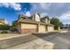 Exterior of a townhouse featuring a garage and well-maintained landscaping at 2117 S Troy Way, Aurora, CO 80014