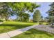 A landscaped green space with mature trees, shrubbery and a sidewalk at 2117 S Troy Way, Aurora, CO 80014