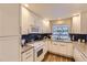 Bright kitchen with white cabinets, granite countertops, and modern appliances at 2117 S Troy Way, Aurora, CO 80014