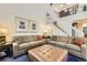 Inviting living room with a fireplace, plush seating, and a large ottoman at 2117 S Troy Way, Aurora, CO 80014