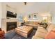 Inviting living room with a fireplace, plush seating, and a large ottoman at 2117 S Troy Way, Aurora, CO 80014