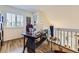 Bright office space featuring a large window and a wicker desk at 2117 S Troy Way, Aurora, CO 80014