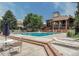 A community pool with brick trim and a covered seating area is available for residents to enjoy on a sunny day at 2117 S Troy Way, Aurora, CO 80014