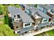 Modern townhomes showcasing rooftop terraces, stylish architecture, and landscaped surroundings at 4035 Fenton Ct, Wheat Ridge, CO 80212