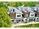 Aerial view of modern townhomes featuring rooftop decks, sleek design, and beautiful landscaping at 4035 Fenton Ct, Wheat Ridge, CO 80212