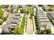 An aerial view of a townhome community with well-manicured lawns, mature trees, and modern architecture at 4035 Fenton Ct, Wheat Ridge, CO 80212