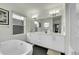 Bathroom with a modern freestanding tub, dual sinks, and sleek fixtures at 4035 Fenton Ct, Wheat Ridge, CO 80212