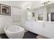 Bathroom with a modern freestanding tub, dual sinks, and sleek fixtures at 4035 Fenton Ct, Wheat Ridge, CO 80212