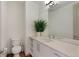 Modern bathroom features sleek fixtures, a large mirror, and stylish vanity with open shelving at 4035 Fenton Ct, Wheat Ridge, CO 80212