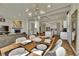 Open concept dining and living room area boasts hardwood floors, modern lighting, and fireplace at 4035 Fenton Ct, Wheat Ridge, CO 80212