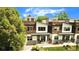 Modern townhomes with clean lines, lush trees, and charming curb appeal under a blue sky at 4035 Fenton Ct, Wheat Ridge, CO 80212