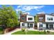 Contemporary two-story home with mixed siding, a manicured lawn, and inviting front porch at 4035 Fenton Ct, Wheat Ridge, CO 80212