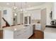Modern kitchen features an island, stainless steel appliances, and sleek white cabinets at 4035 Fenton Ct, Wheat Ridge, CO 80212