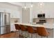 Modern kitchen with stainless steel appliances, quartz countertops, and a large center island with seating at 4035 Fenton Ct, Wheat Ridge, CO 80212
