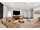 Comfortable basement living room with a large sectional sofa, entertainment center, and neutral decor at 4035 Fenton Ct, Wheat Ridge, CO 80212