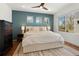 Stylish main bedroom with teal accent wall, king bed, three windows, and a ceiling fan at 4035 Fenton Ct, Wheat Ridge, CO 80212