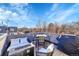 Inviting rooftop deck with outdoor seating, dining table, and grill, perfect for relaxing or entertaining at 4035 Fenton Ct, Wheat Ridge, CO 80212