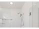 Modern shower with dual shower heads, glass doors, and built-in shelving for toiletries at 4035 Fenton Ct, Wheat Ridge, CO 80212