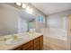 Bathroom features a double sink vanity, soaking tub, and glass-enclosed shower at 4821 N Silverlace Dr, Castle Rock, CO 80109