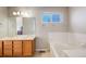 Bathroom features a double sink vanity, soaking tub, and a window at 4821 N Silverlace Dr, Castle Rock, CO 80109