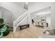 Bright entryway with stairs, hardwood floors, and a view into the dining room, creating a welcoming and open space at 4821 N Silverlace Dr, Castle Rock, CO 80109