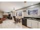 Bright kitchen with a view into the cozy living room with a brick fireplace at 4821 N Silverlace Dr, Castle Rock, CO 80109